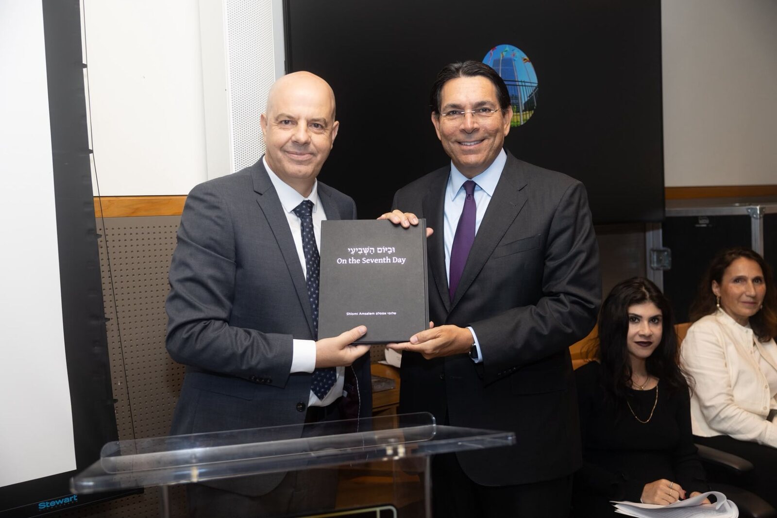 Shlomi Amsalem and Israel’s Ambassador to the UN Danny Danon holding the book “On the Seventh Day” together