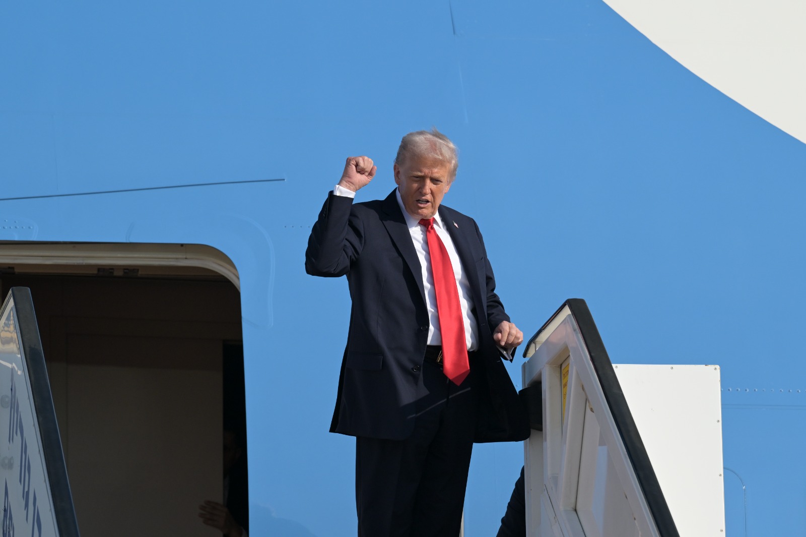 President Donald Trump raises a fist at the door of Air Force One on landing at Ben Gurion Airport